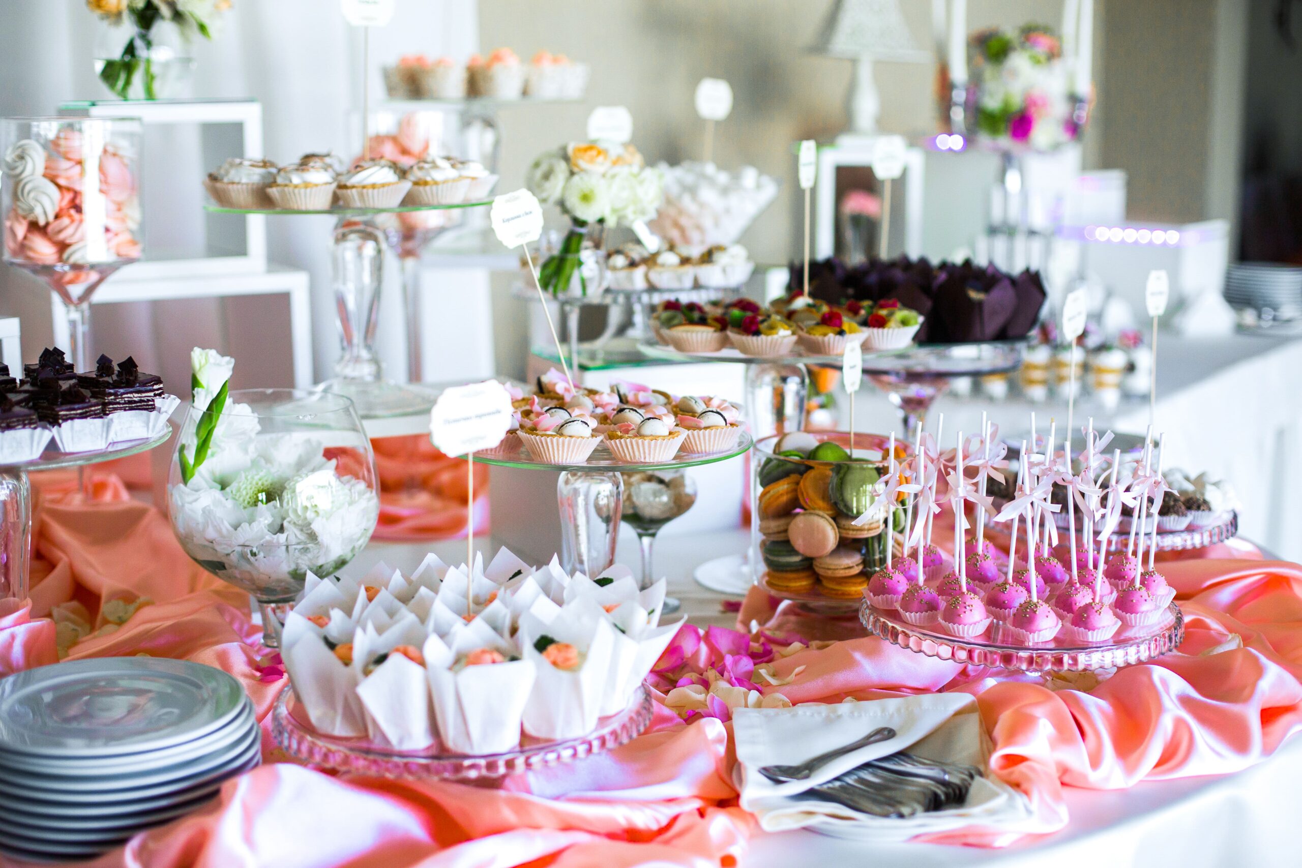 table-with-delicious-sweets-covered-with-pink-silk